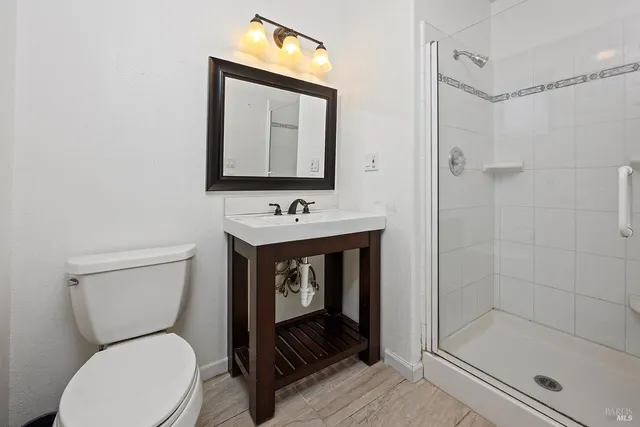 a bathroom with a toilet sink and shower