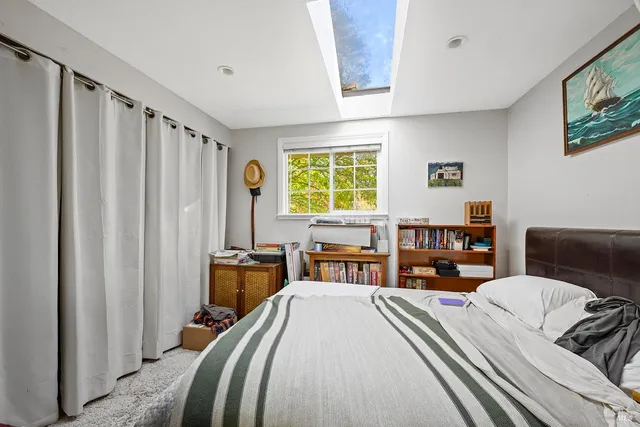 a bedroom with a bed furniture and a window