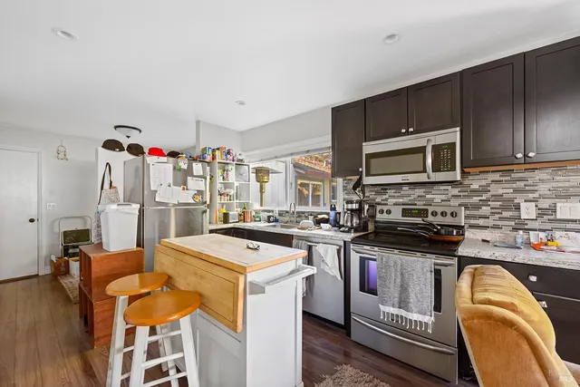 a kitchen that has a sink and a stove top oven