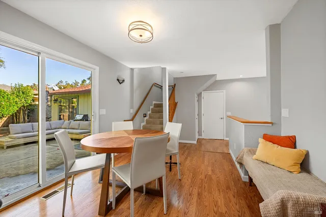 a view of a dining room with furniture wooden floor and a large window