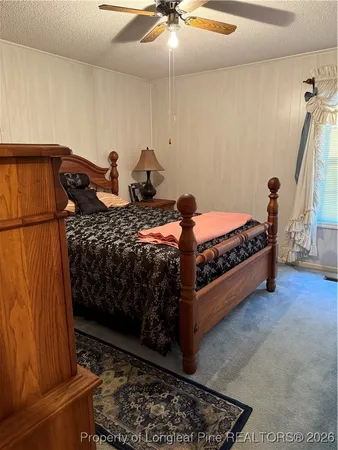 a bed room with furniture and a window