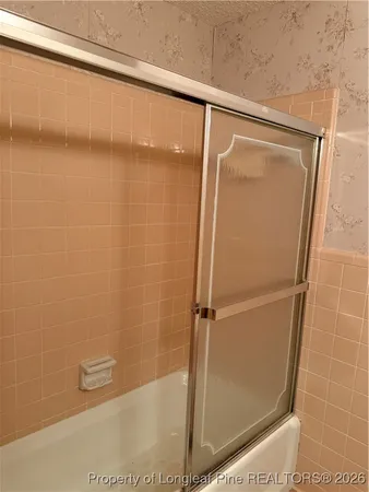 a bathroom with a glass shower door