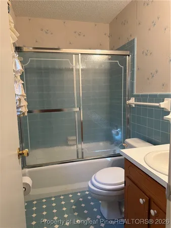 a bathroom with a shower a toilet and sink