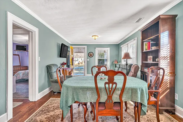 a bedroom with a bed a chair and a large window