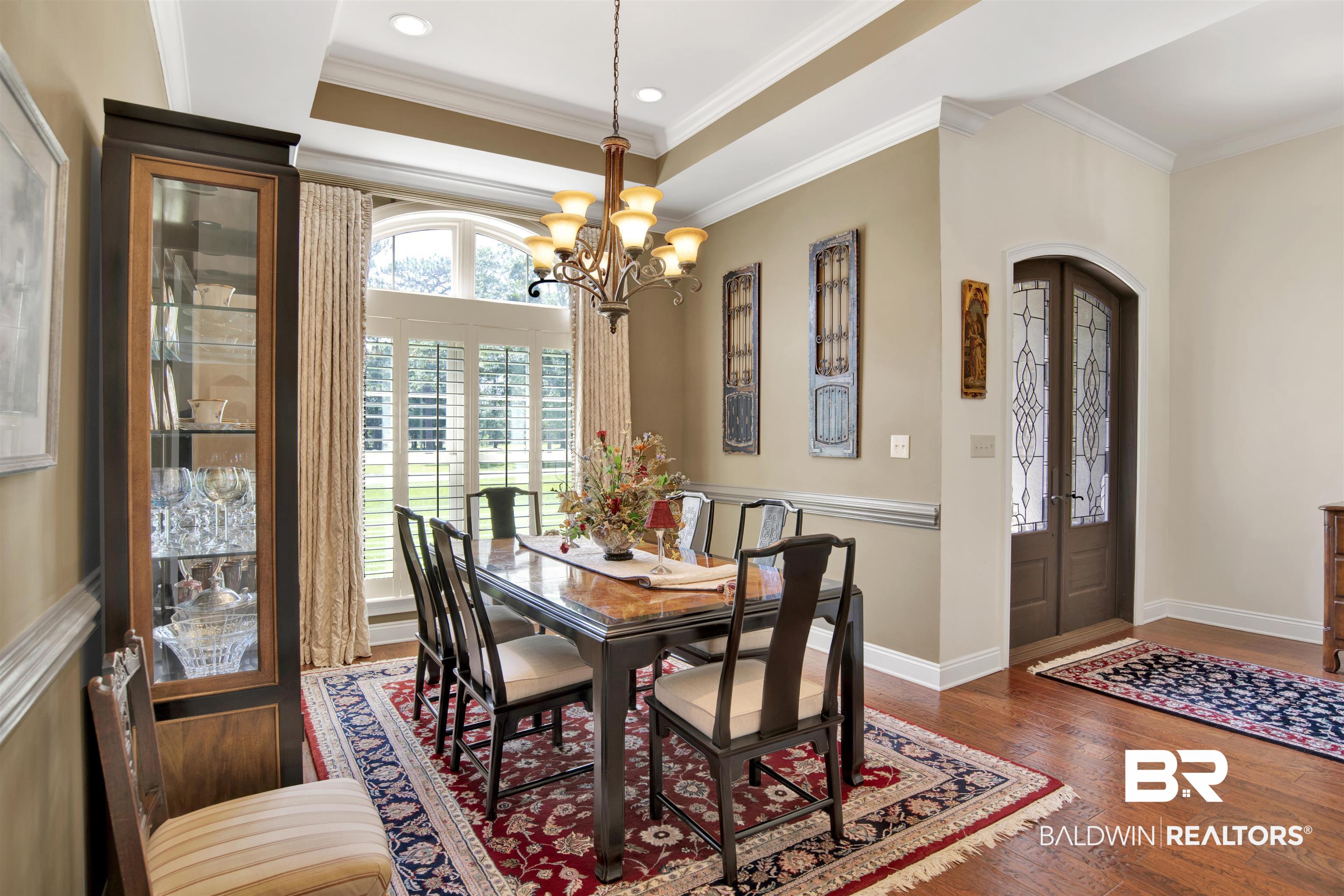 8358 Forest Lane Foley, AL 36535 - Photo 36 of 46 Dining area with a chandelier, wood finished floors, crown molding, recessed lighting, and arched walkways