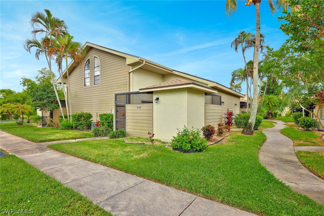 13373 Broadhurst Loop Fort Myers, FL 33919 - Photo 1 of 25 a front view of a house with garden