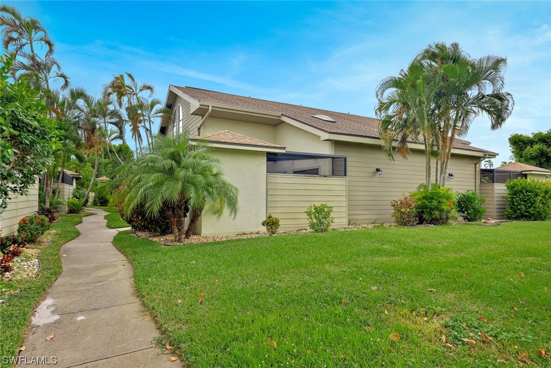 13373 Broadhurst Loop Fort Myers, FL 33919 - Photo 21 of 25 a front view of a house with a garden