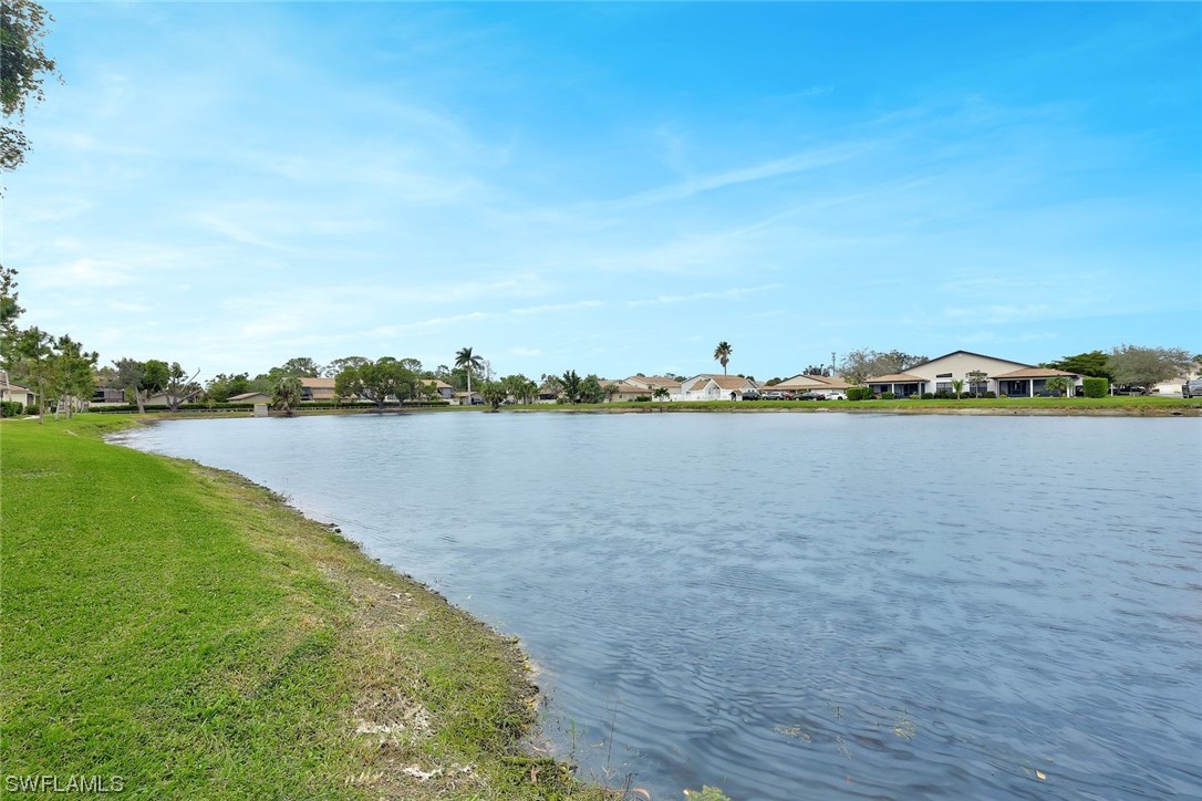 13373 Broadhurst Loop Fort Myers, FL 33919 - Photo 23 of 25 a view of a lake with houses in the back
