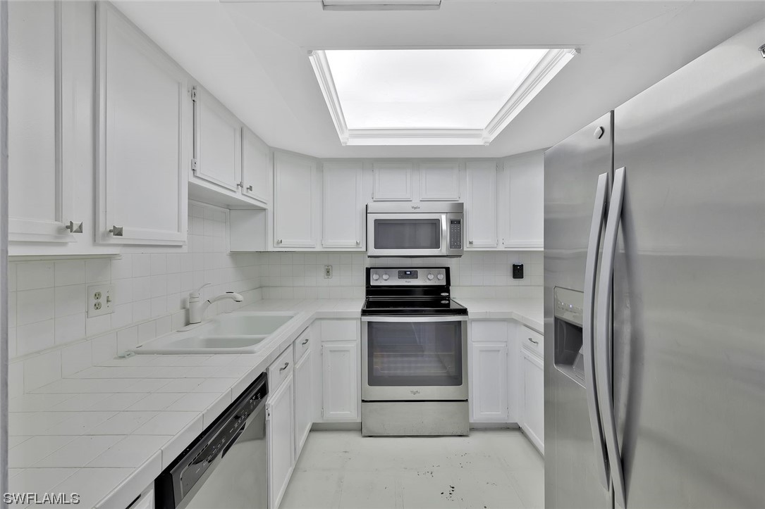 13373 Broadhurst Loop Fort Myers, FL 33919 - Photo 5 of 25 a kitchen with stainless steel appliances a refrigerator sink and microwave