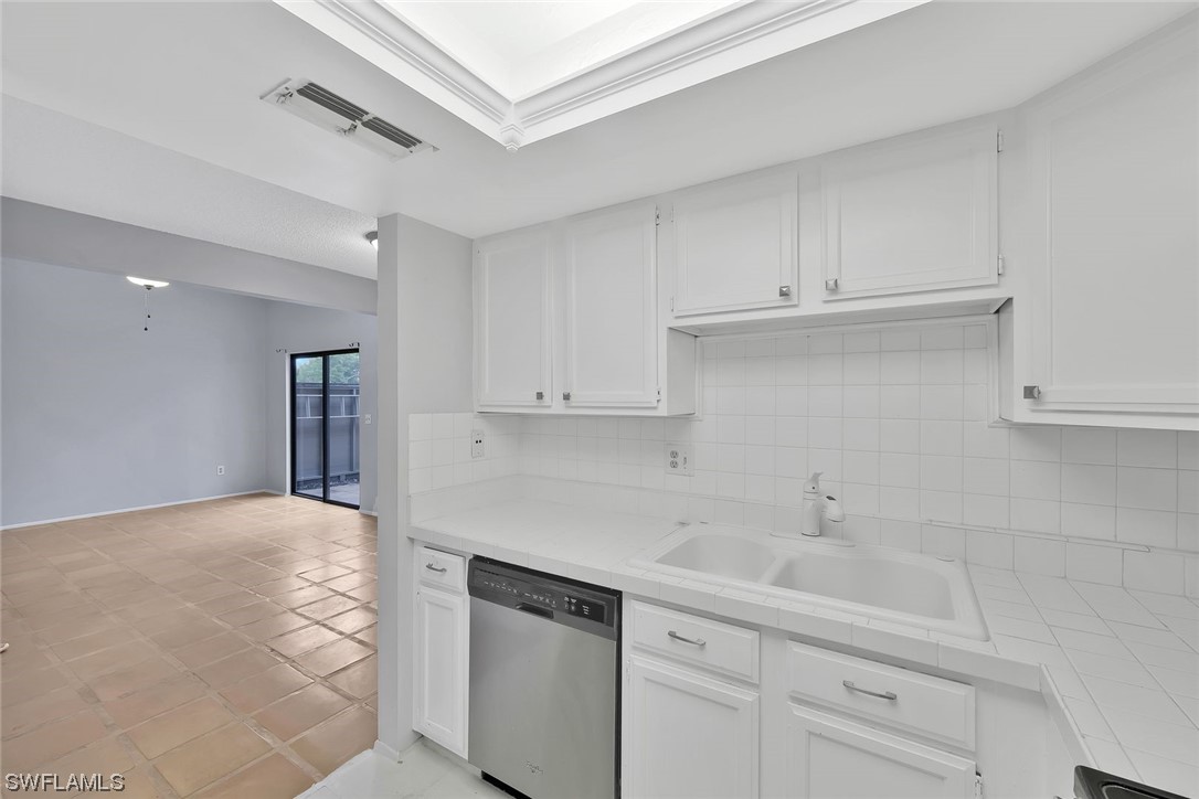 13373 Broadhurst Loop Fort Myers, FL 33919 - Photo 7 of 25 a kitchen with white cabinets and a sink