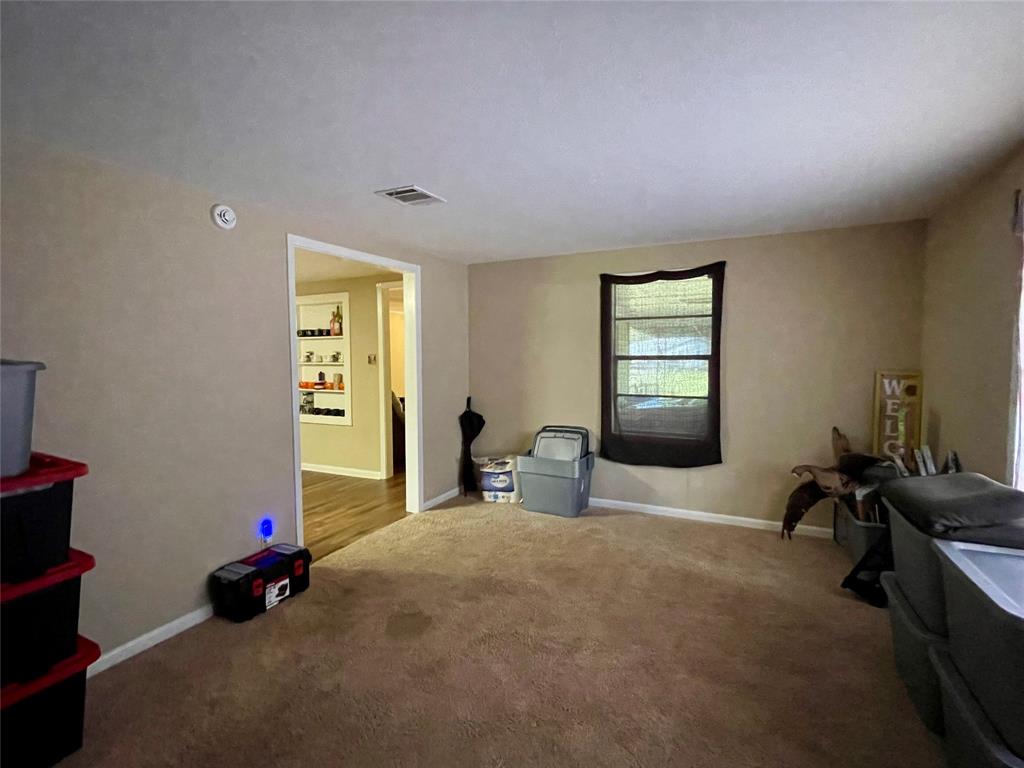 10806 Newson Road Keithville, LA 71047 - Photo 11 of 24 a bedroom with bed and window