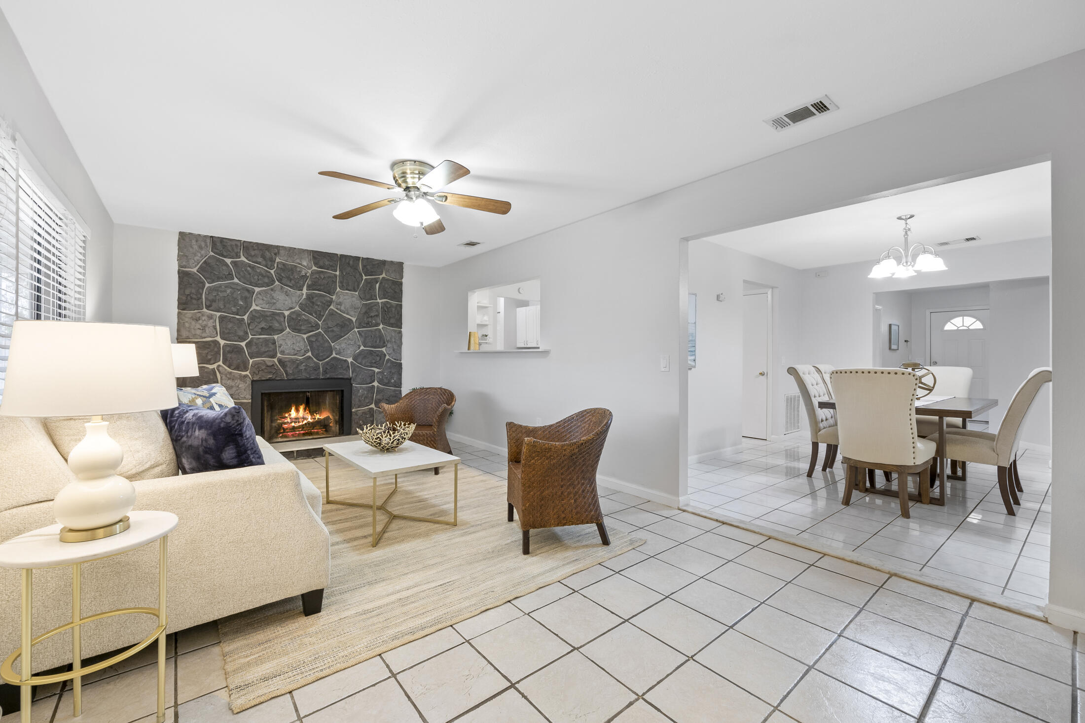 1180 Mascot Street Northeast Palm Bay, FL 32905 - Photo 11 of 24 a living room with furniture a fireplace and a chandelier