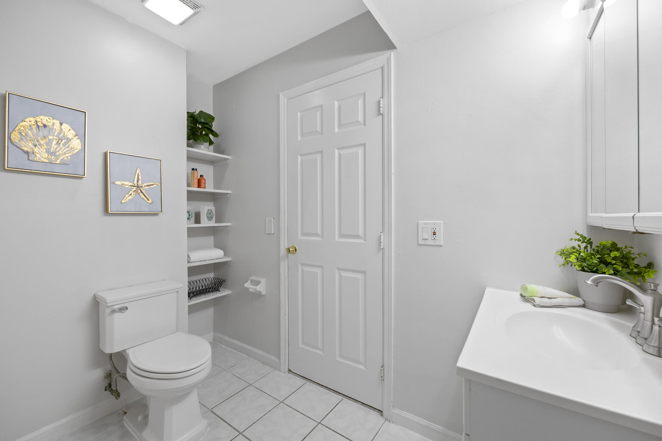 1180 Mascot Street Northeast Palm Bay, FL 32905 - Photo 16 of 24 a bathroom with a sink toilet and a mirror