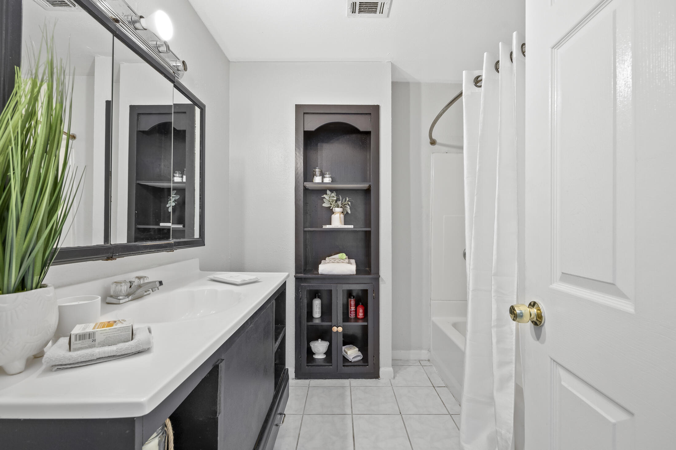 1180 Mascot Street Northeast Palm Bay, FL 32905 - Photo 18 of 24 a bathroom with a sink vanity and a mirror