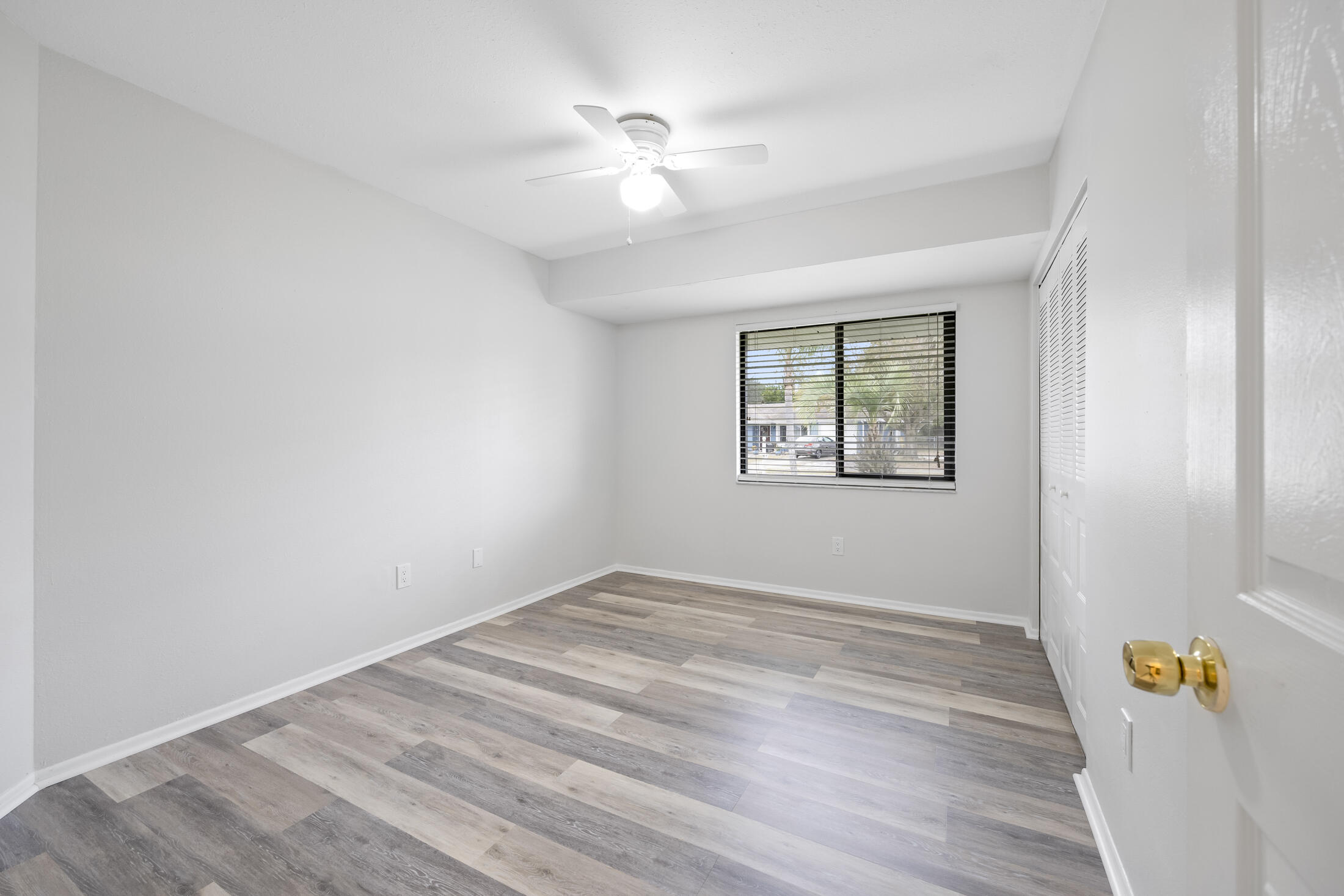 1180 Mascot Street Northeast Palm Bay, FL 32905 - Photo 19 of 24 wooden floor in an empty room with a window