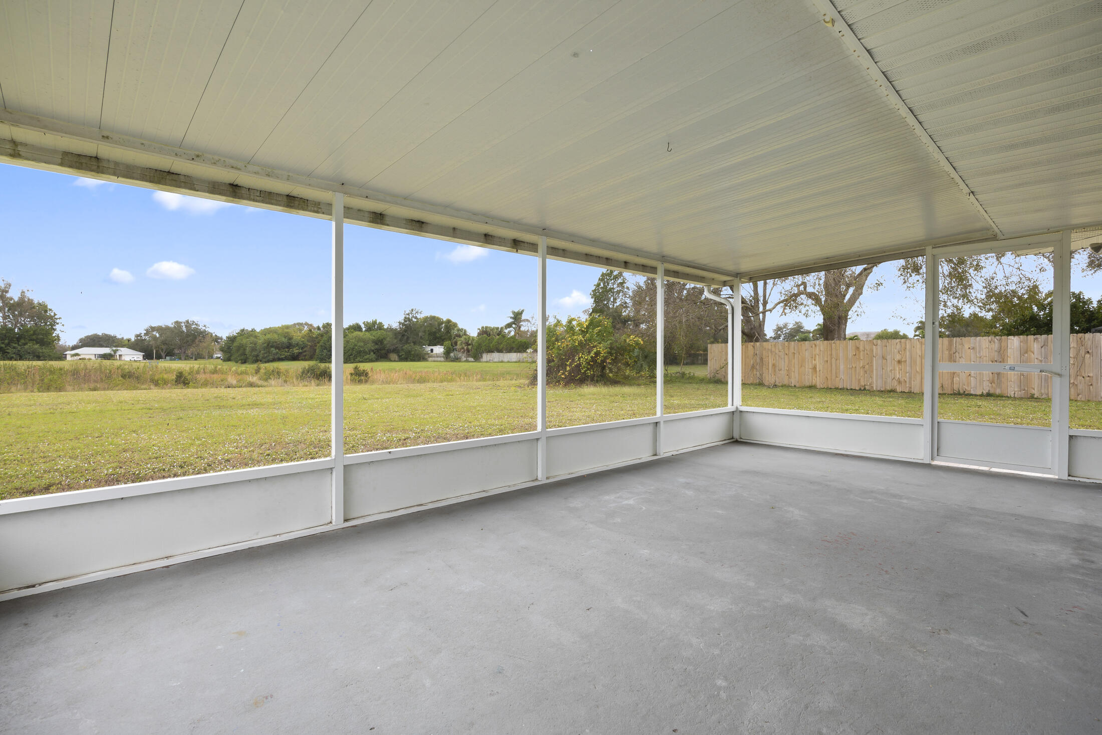 1180 Mascot Street Northeast Palm Bay, FL 32905 - Photo 20 of 24 a view of an empty room with a floor to ceiling window and an outdoor kitchen