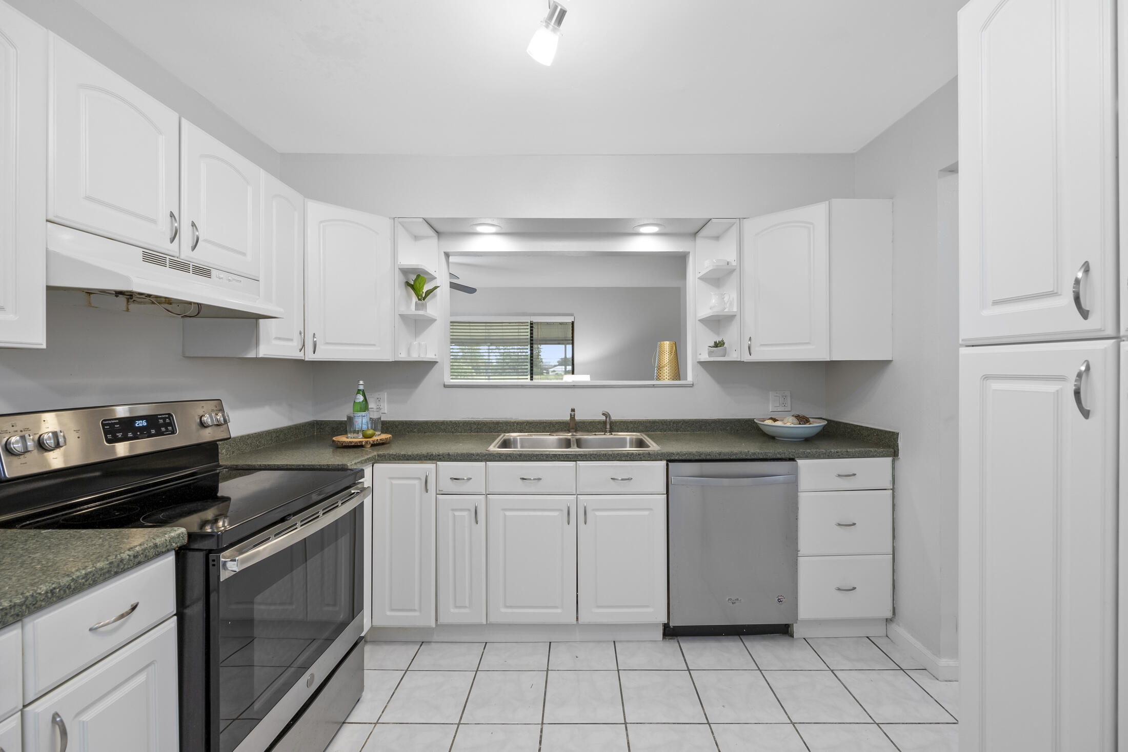 1180 Mascot Street Northeast Palm Bay, FL 32905 - Photo 6 of 24 a kitchen with a stove sink and cabinets