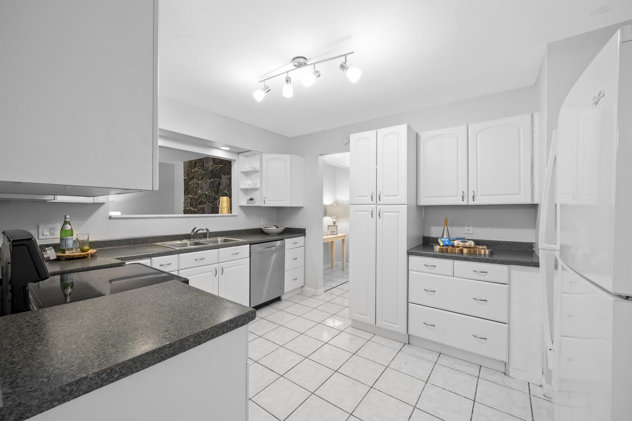 1180 Mascot Street Northeast Palm Bay, FL 32905 - Photo 7 of 24 a kitchen with white cabinets and appliances