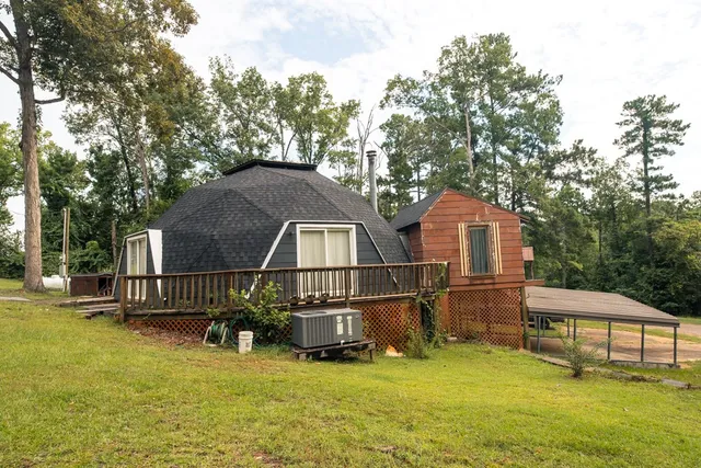 a view of a house with swimming pool and sitting area