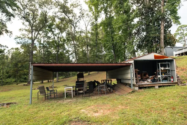 a view of yard with swimming pool and trees