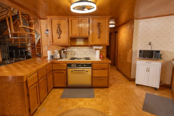 a kitchen with a sink and a stove top oven