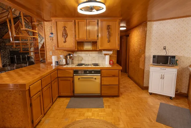 a kitchen with a sink and a stove top oven