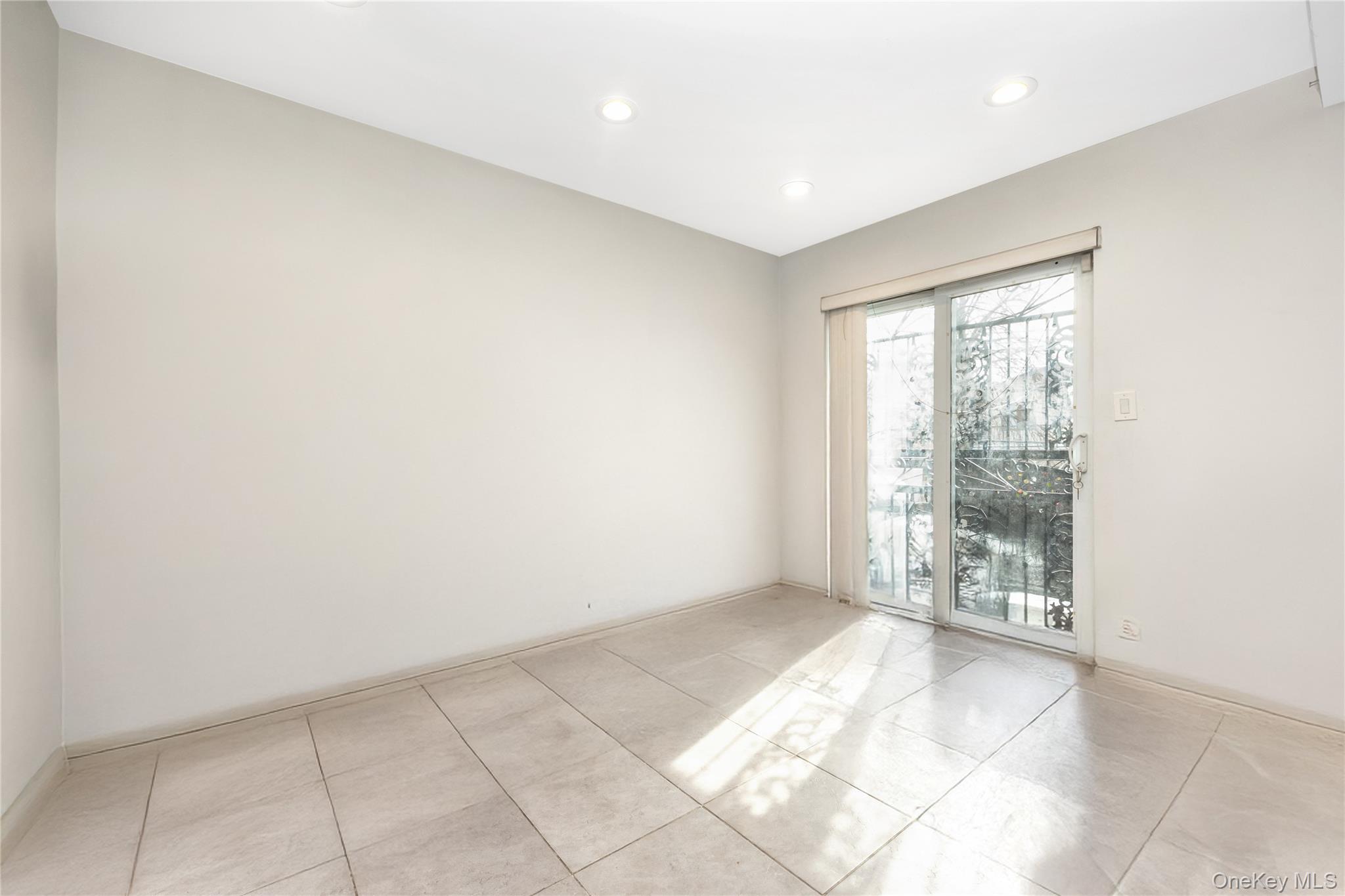 71-59 58th Road Queens, NY 11378 - Photo 12 of 34 a view of an empty room with a window