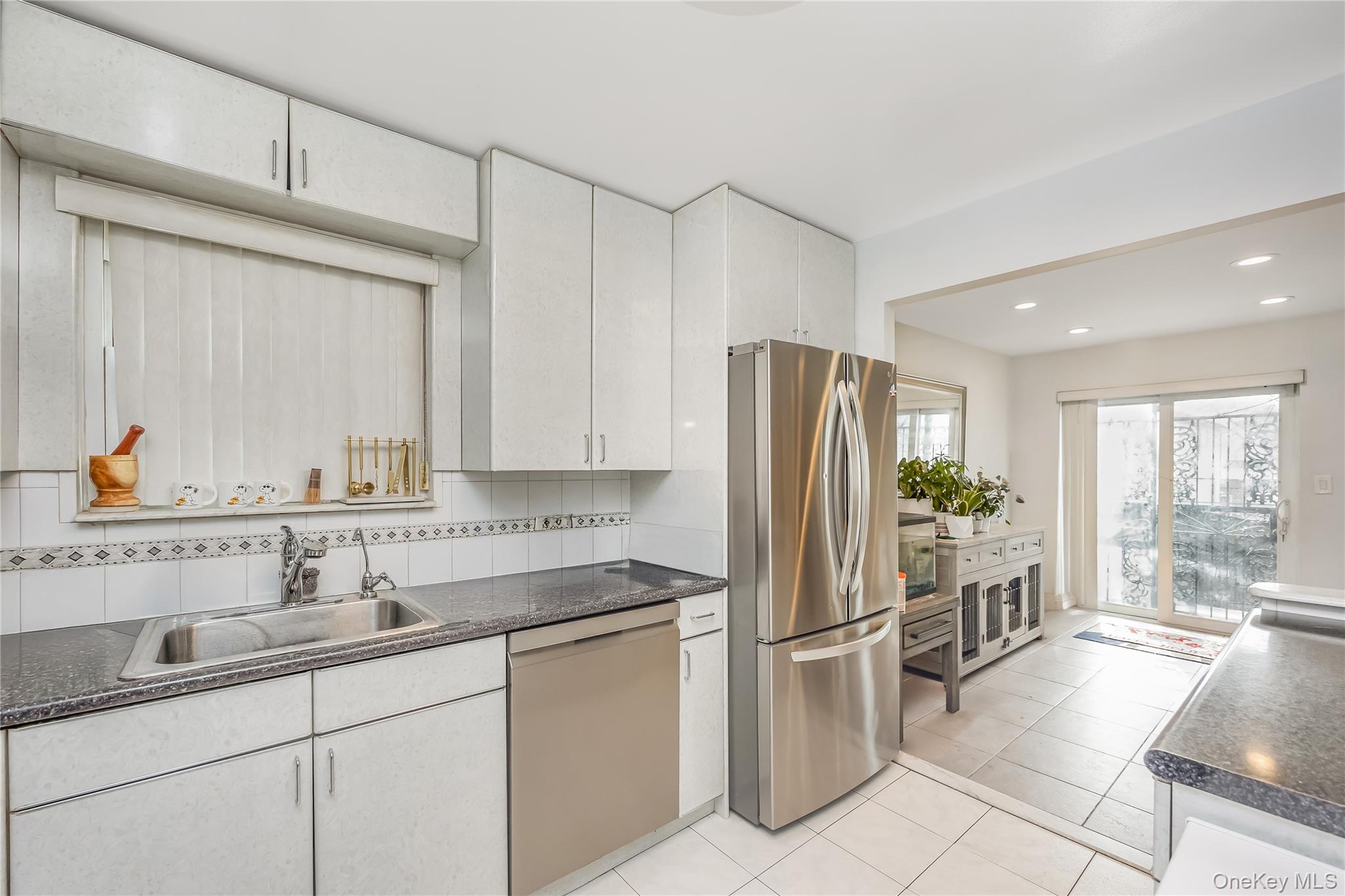 71-59 58th Road Queens, NY 11378 - Photo 14 of 34 a kitchen with stainless steel appliances a refrigerator sink and cabinets