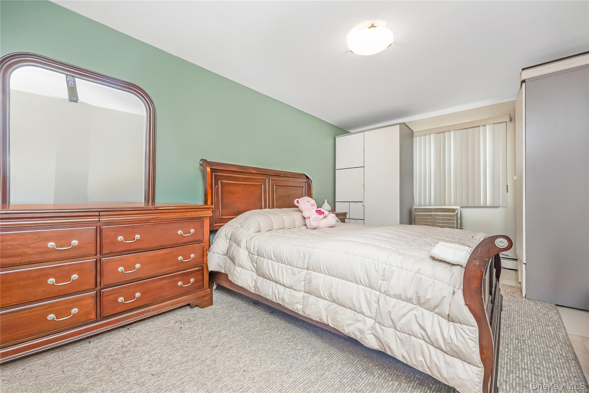 71-59 58th Road Queens, NY 11378 - Photo 19 of 34 a bedroom with a bed and a dresser