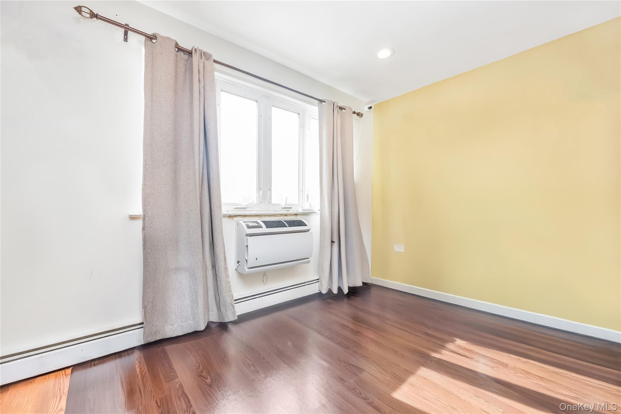 71-59 58th Road Queens, NY 11378 - Photo 22 of 34 a view of empty room with wooden floor