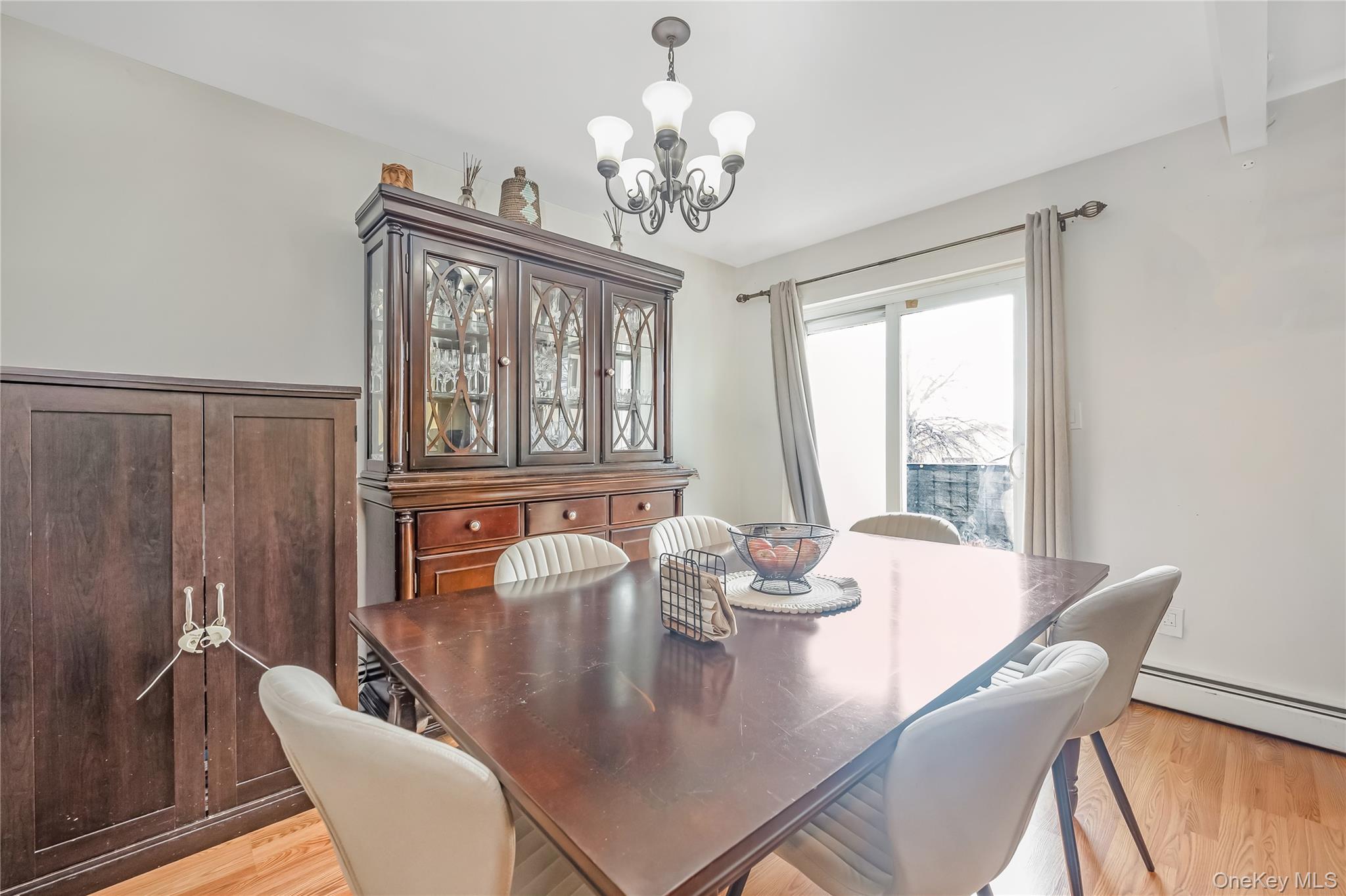 71-59 58th Road Queens, NY 11378 - Photo 23 of 34 a view of a dining room with furniture a chandelier and wooden floor