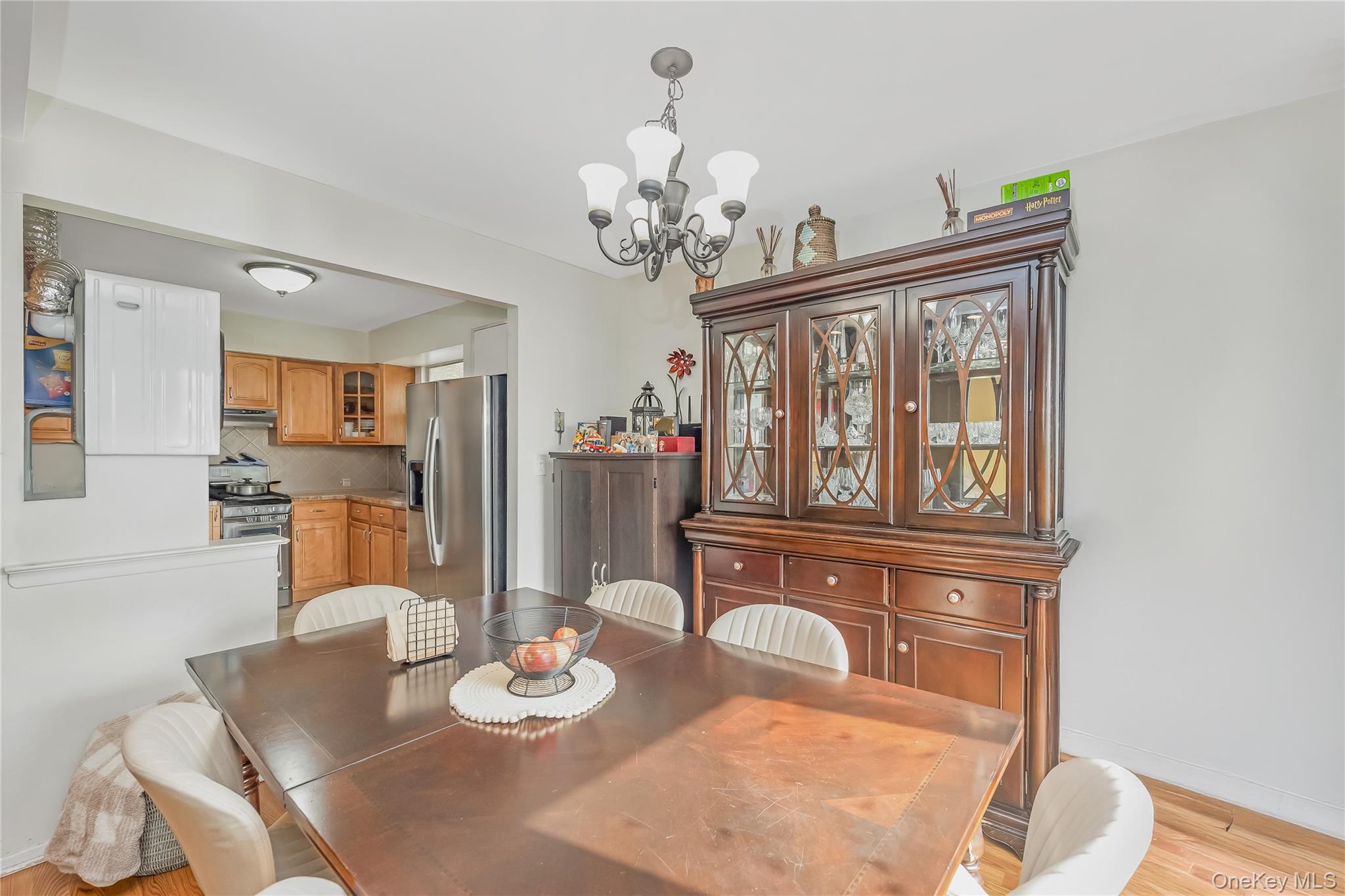 71-59 58th Road Queens, NY 11378 - Photo 24 of 34 a view of a dining room with furniture a chandelier and wooden floor