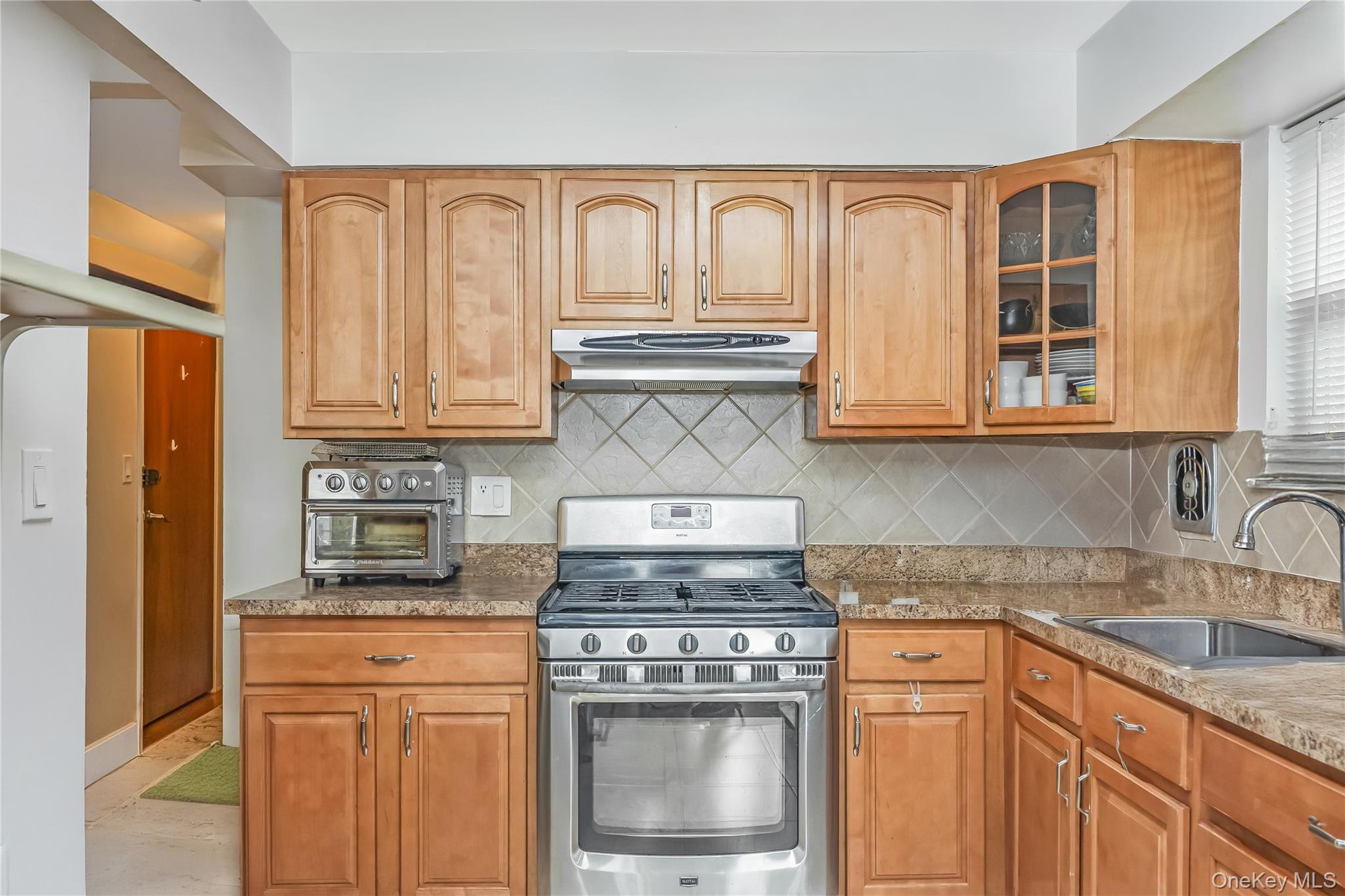 71-59 58th Road Queens, NY 11378 - Photo 25 of 34 a stove top oven sitting inside of a kitchen