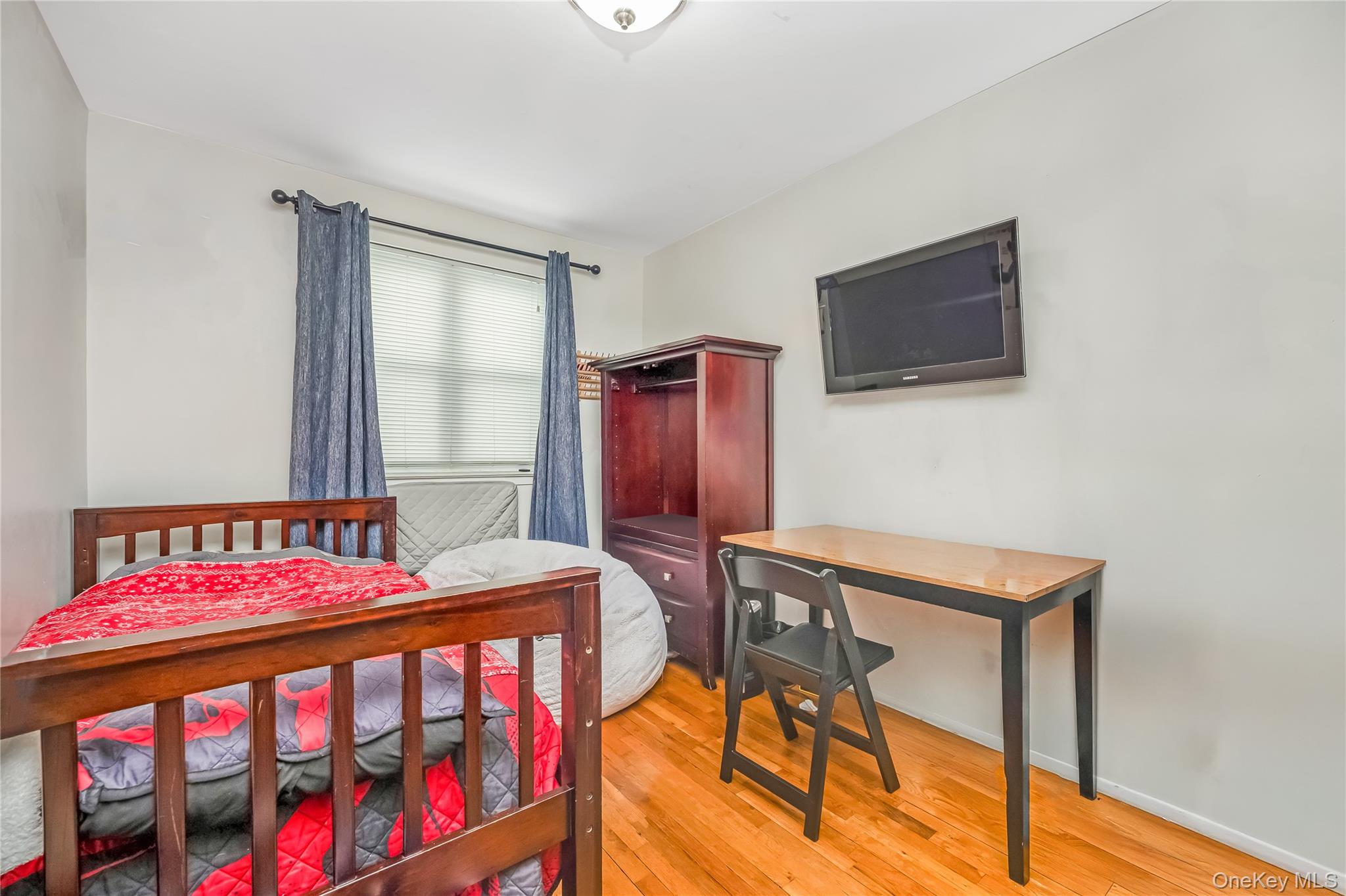 71-59 58th Road Queens, NY 11378 - Photo 28 of 34 a bedroom with a bed and a tv in it