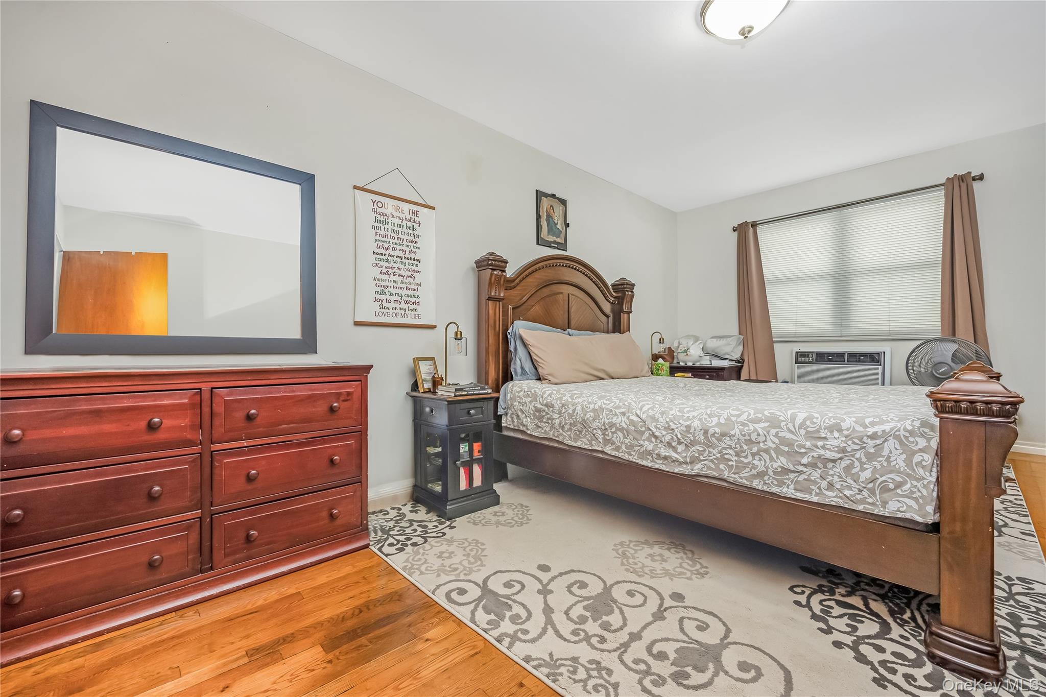 71-59 58th Road Queens, NY 11378 - Photo 30 of 34 a bedroom with a large bed and a dresser