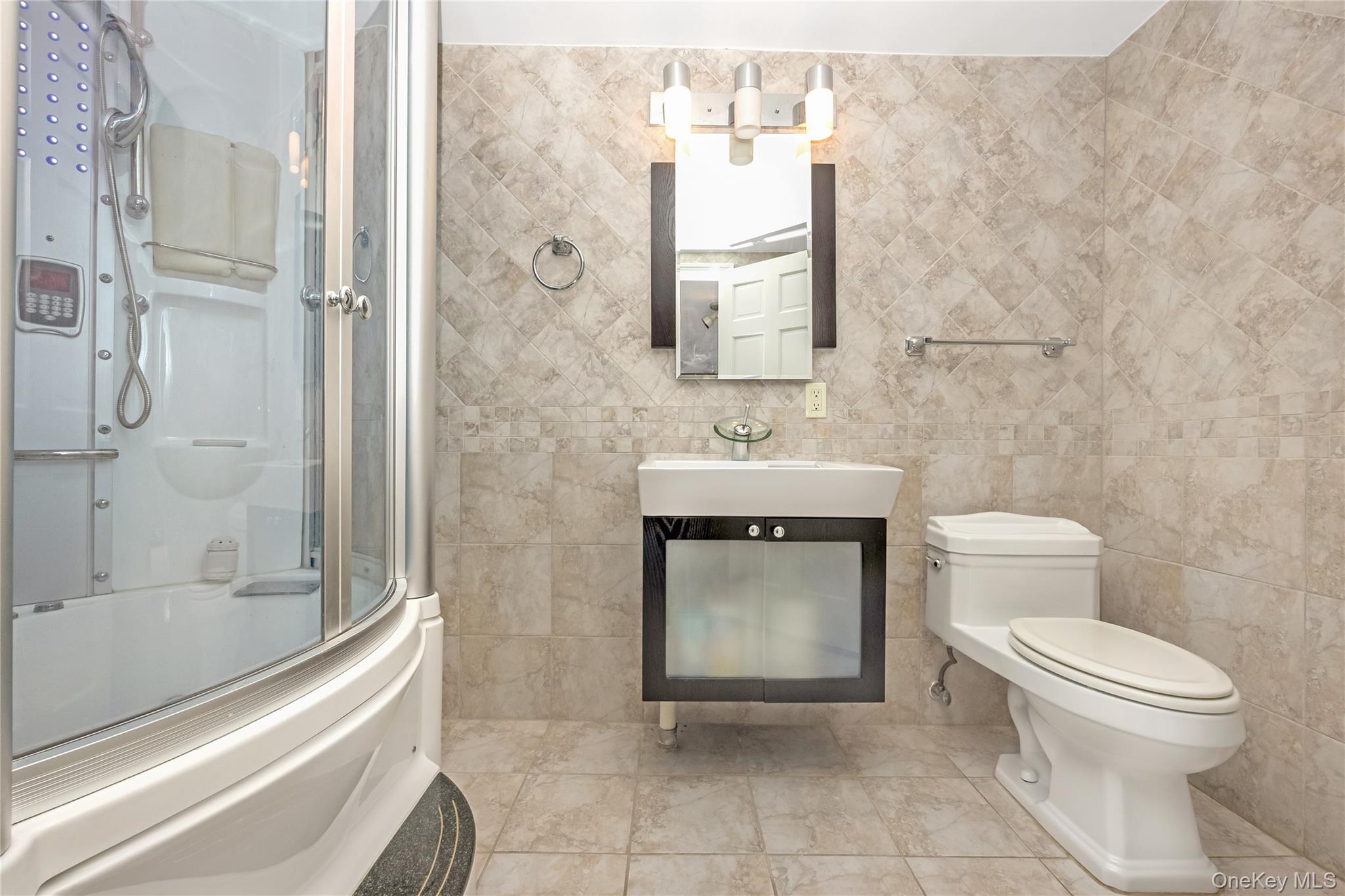 71-59 58th Road Queens, NY 11378 - Photo 34 of 34 a bathroom with a toilet sink and shower