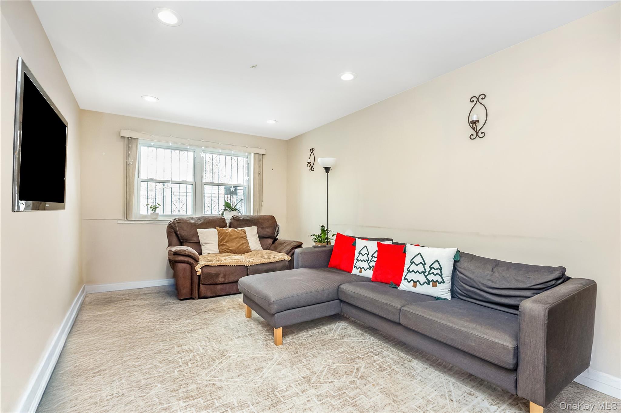 71-59 58th Road Queens, NY 11378 - Photo 5 of 34 a living room with furniture and a flat screen tv