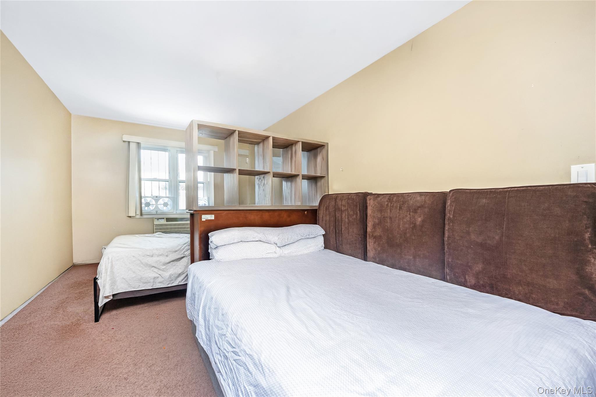 71-59 58th Road Queens, NY 11378 - Photo 7 of 34 a bedroom with a bed and window