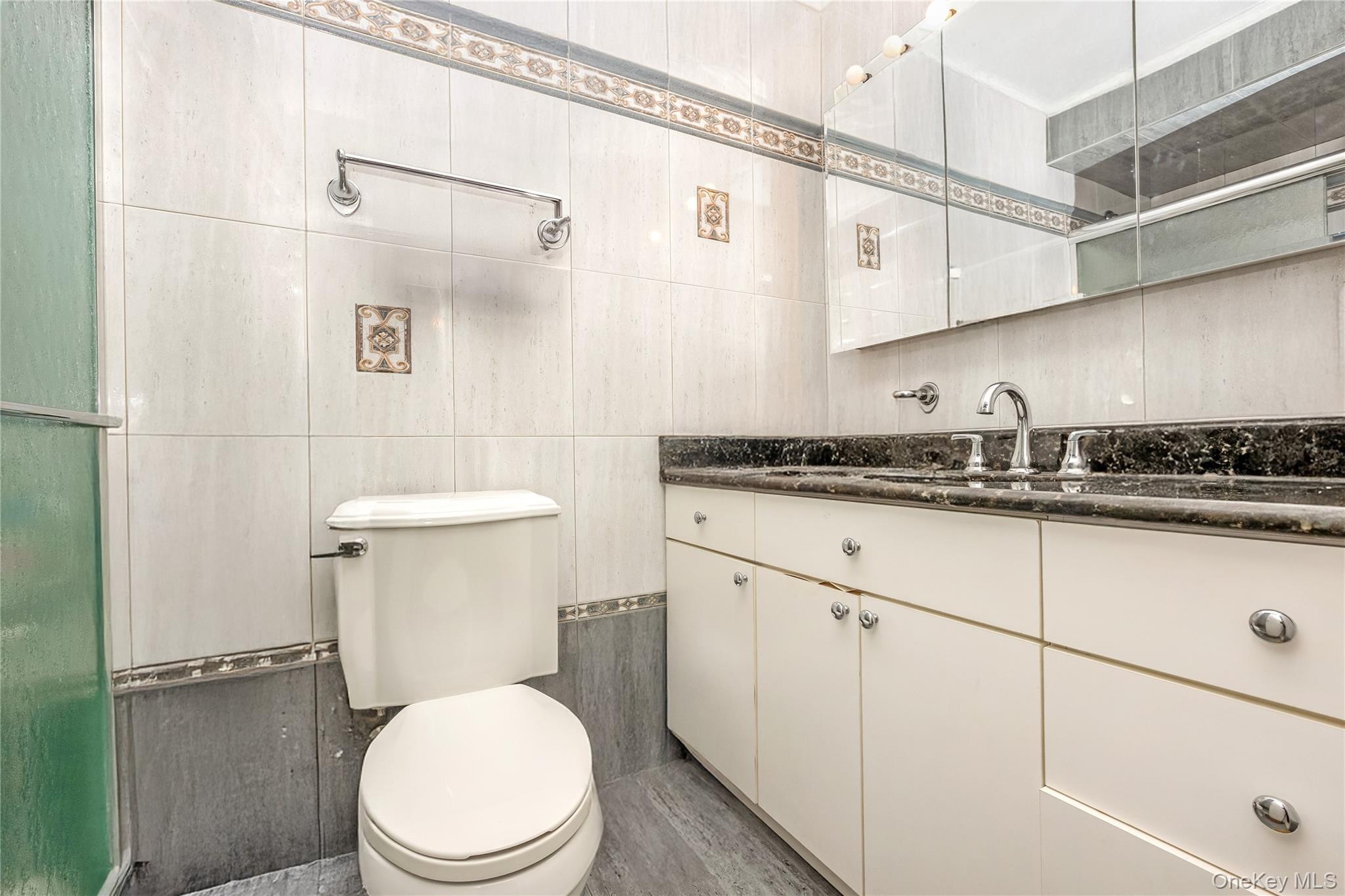 71-59 58th Road Queens, NY 11378 - Photo 8 of 34 a white toilet sitting next to a bathroom sink