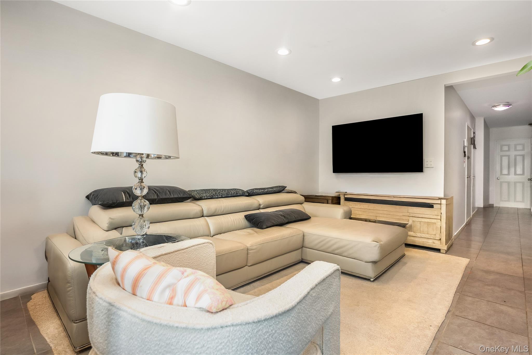 71-59 58th Road Queens, NY 11378 - Photo 10 of 34 a living room with furniture and a flat screen tv