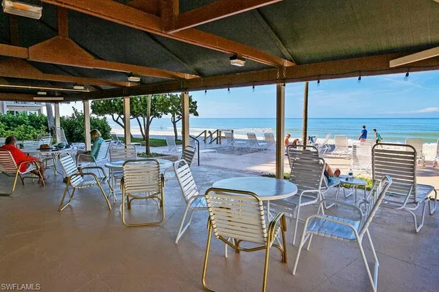 a patio with a table and chairs and a umbrella