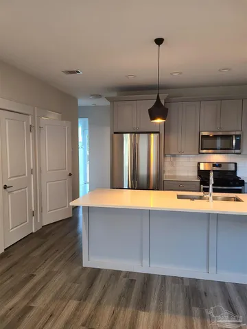 a room with wooden floors and pool table