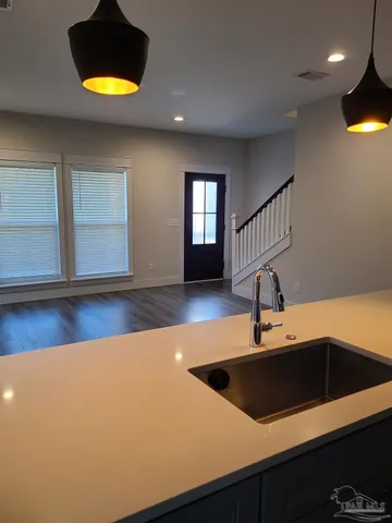 a kitchen with a sink a counter space and a window