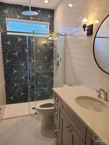 a bathroom with a sink toilet and shower