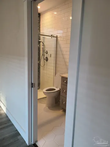 a bathroom with a toilet and a shower