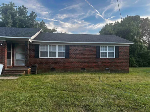 a brick house with a yard
