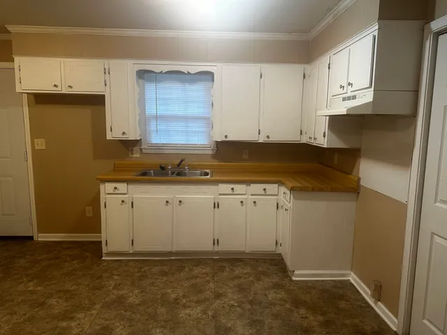 a view of kitchen with white cabinets