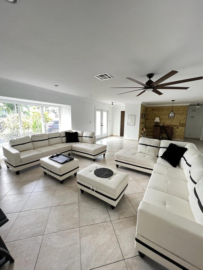 3324 Lakeview Boulevard Delray Beach, FL 33445 - Photo 4 of 36 a living room with furniture and a large window