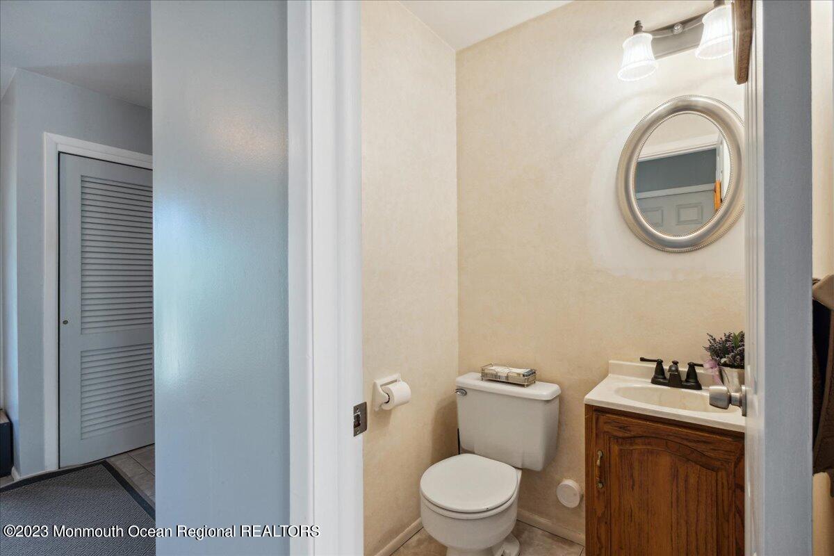 136 Lancaster Road Freehold, NJ 07728 - Photo 17 of 44 a white toilet sitting next to a bathroom sink