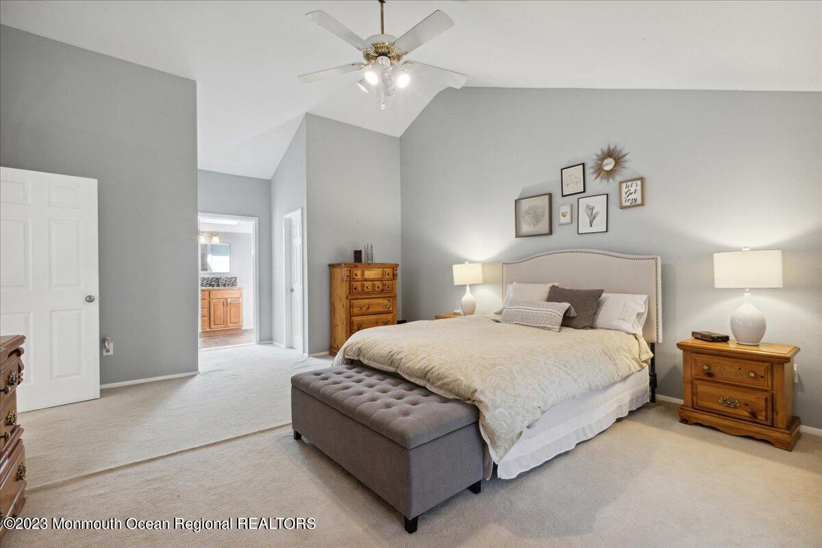 136 Lancaster Road Freehold, NJ 07728 - Photo 23 of 44 a bedroom with a bed ceiling fan and a wooden floor